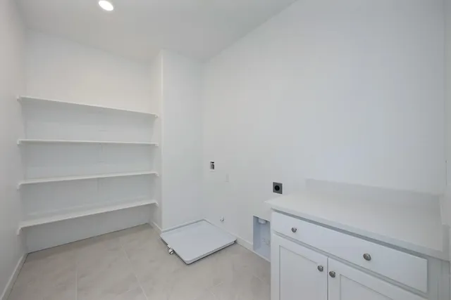 an empty room with windows and entrance