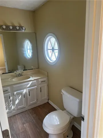 a bathroom with a toilet a sink and mirror