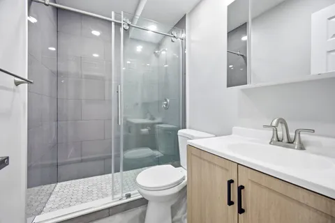 a bathroom with a sink toilet and shower