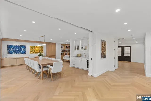 a living room with furniture and kitchen view
