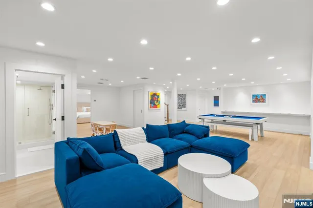 a living room with furniture and a view of kitchen