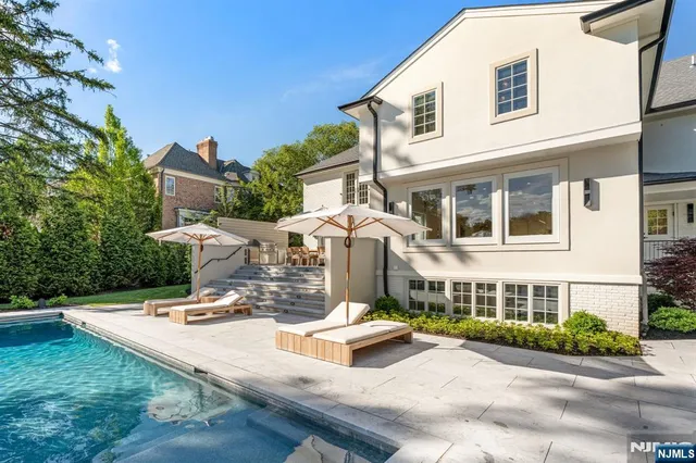 a view of a house with yard and sitting area