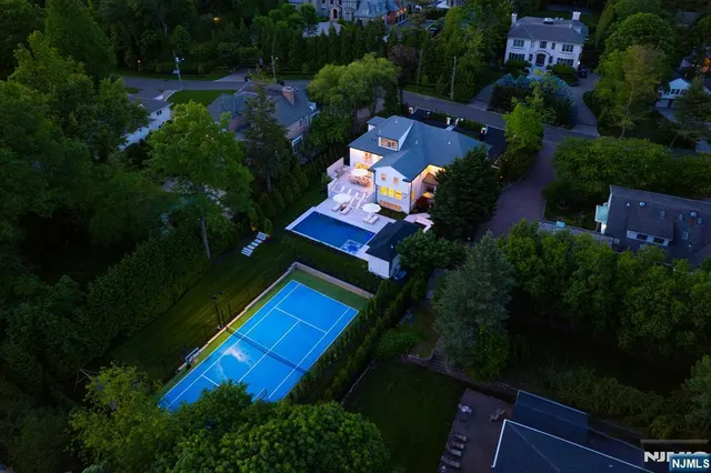 an aerial view of a house yard swimming pool and outdoor seating