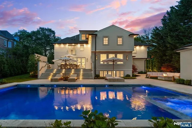 a view of swimming pool with outdoor seating and city in the background