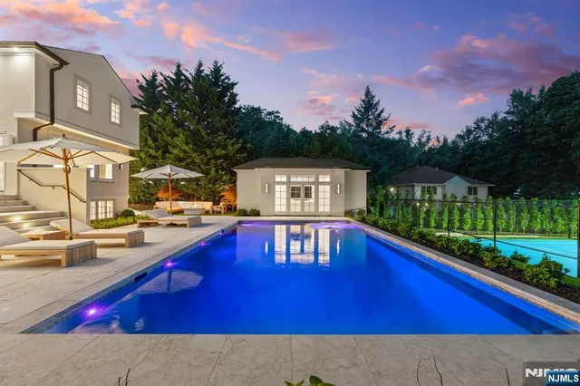 a front view of a house with a garden and yard