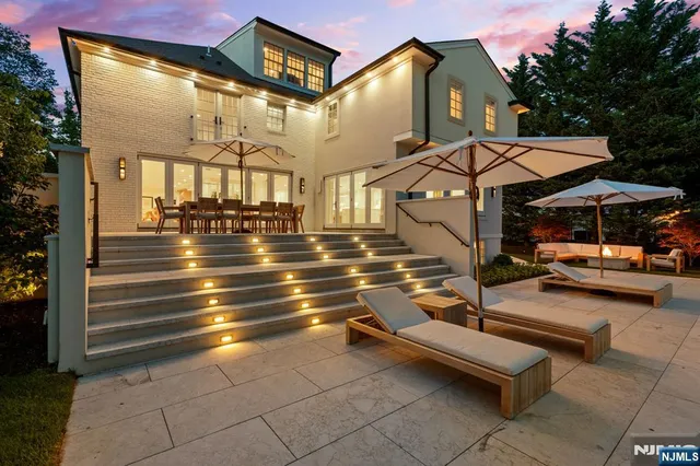 a view of a patio with couches table and chairs and potted plants