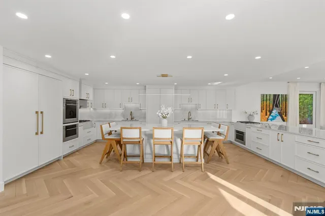 a large kitchen with lots of counter space and stainless steel appliances