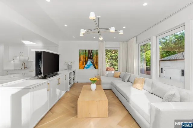 a large living room with large couches and flat screen tv