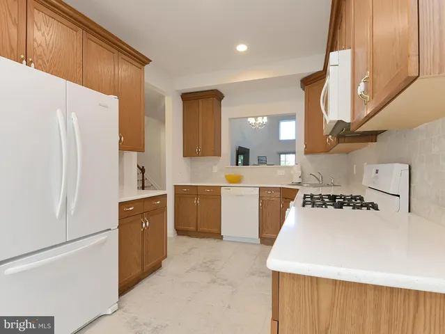 a kitchen with a refrigerator a sink and cabinets
