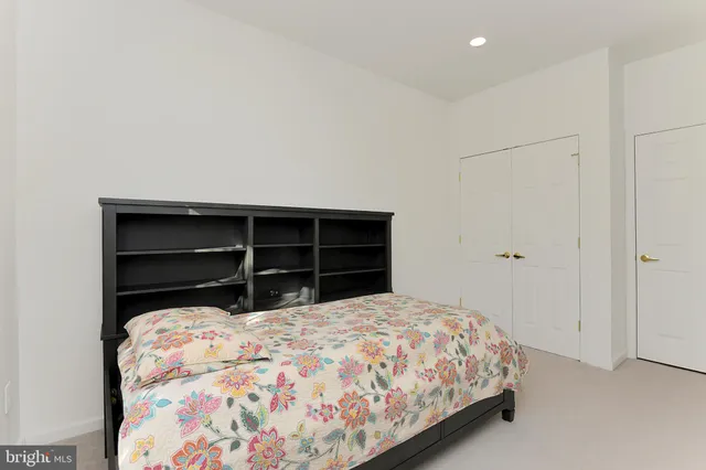 a bedroom with a bed and a closet