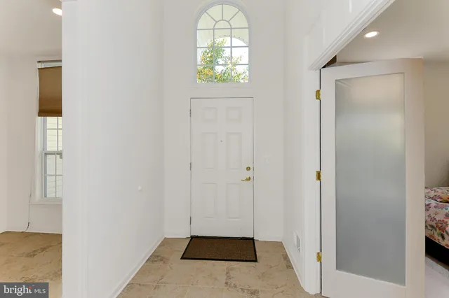 a view of an entryway with wooden floor and window
