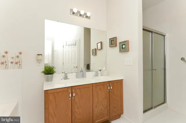 a bathroom with a double vanity sink and a mirror