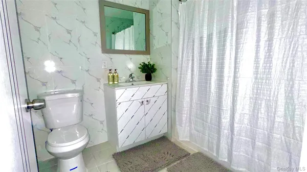 a white toilet sitting next to a shower curtain