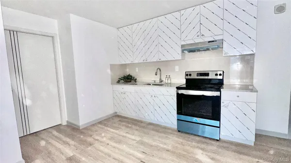 a kitchen with granite countertop a stove and a refrigerator