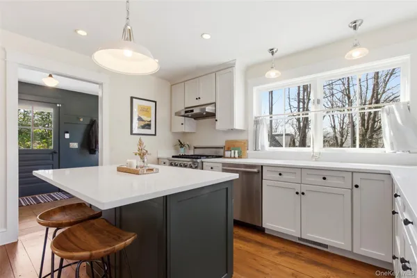 a kitchen with a sink cabinets and wooden floor