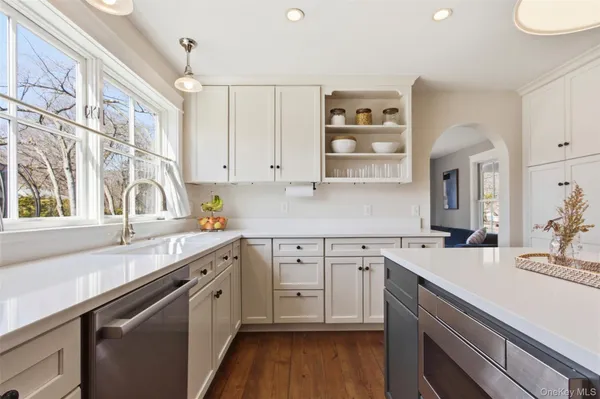 a kitchen with a sink cabinets and wooden floor