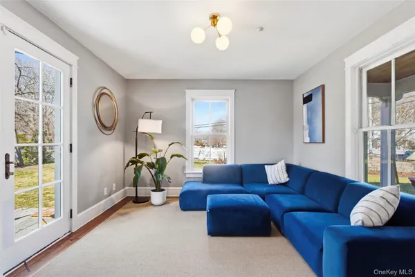 a living room with furniture a window and a chandelier