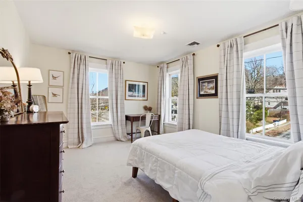 a bedroom with a large bed and a window