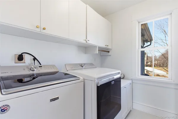 a view of storage and utility room with washer and dryer