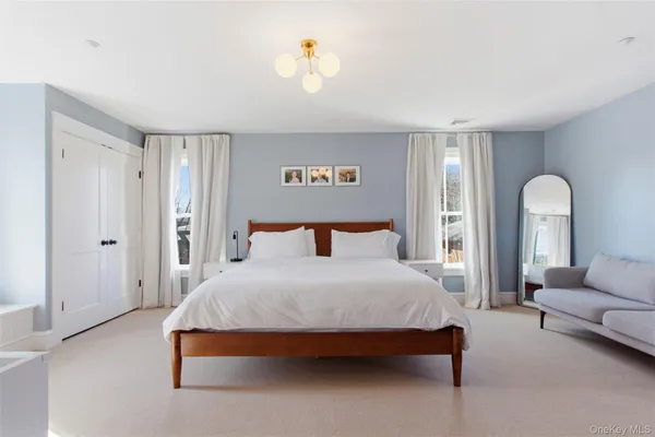 a bedroom with bed and a couch