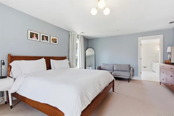 a bedroom with bed and a chandelier