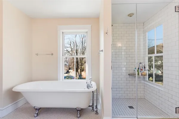 a bathroom with a bathtub and shower