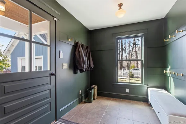 a view of front door with furniture and a window