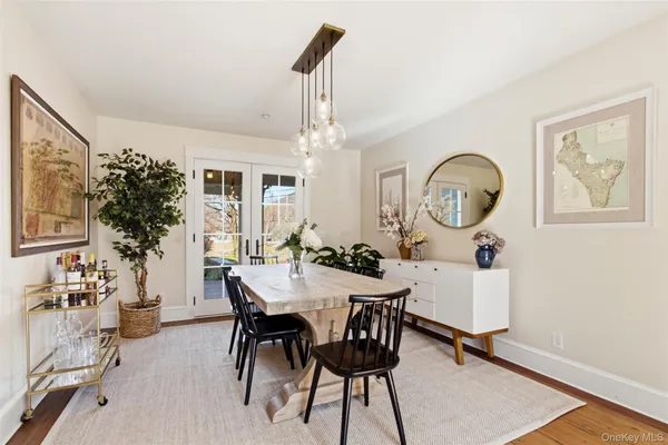 a view of a dining room with furniture and a chandelier