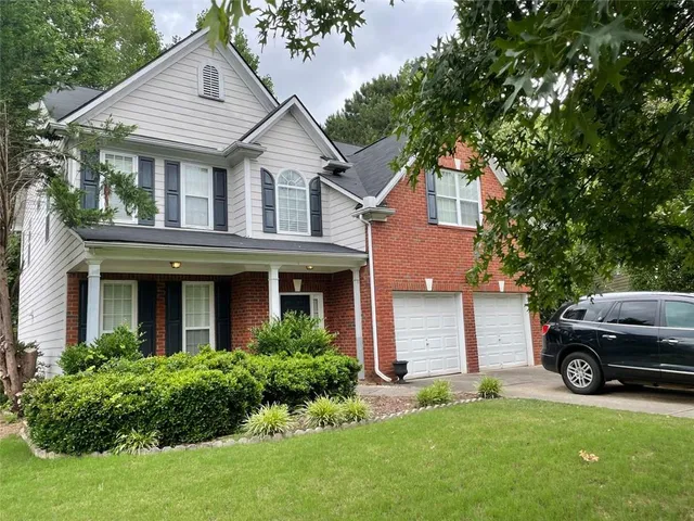 a front view of a house with a yard