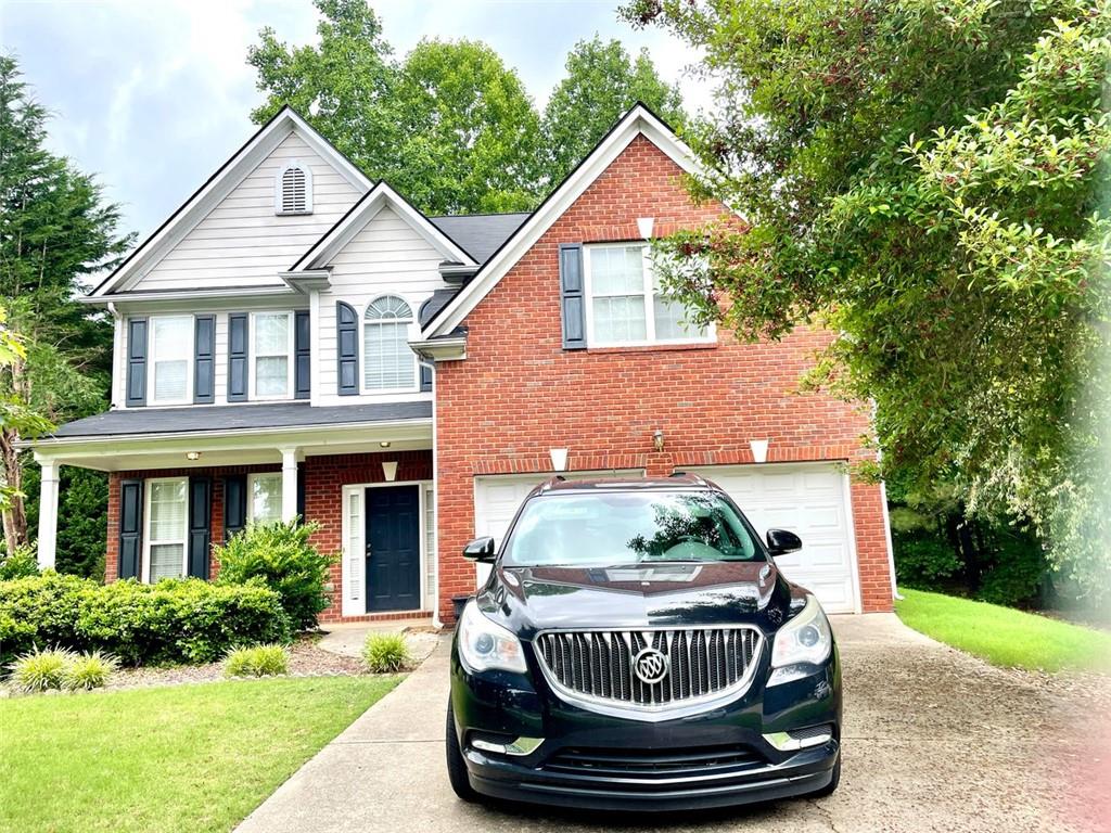 1505 Wedgefield Court Alpharetta, GA 30004 - Photo 2 of 61 a front view of a house with a yard