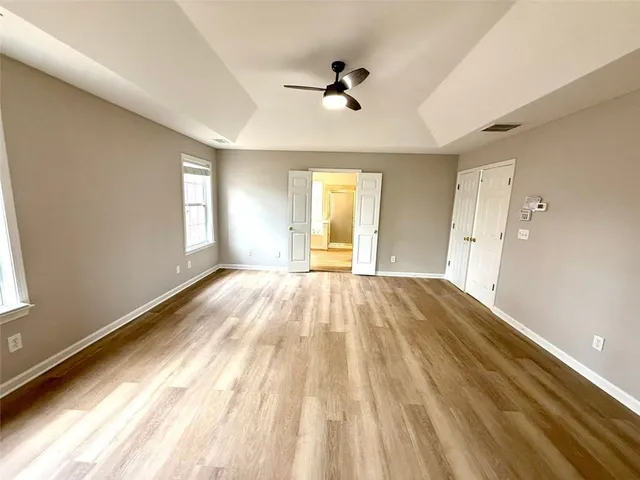 a view of a living room with a sink and dishwasher with wooden floor