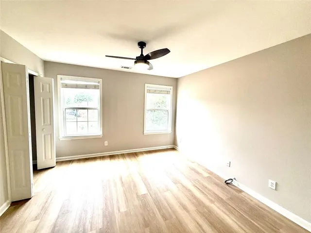 wooden floor in an empty room with a window