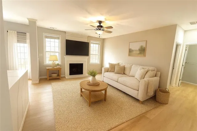 an empty room with windows and fireplace