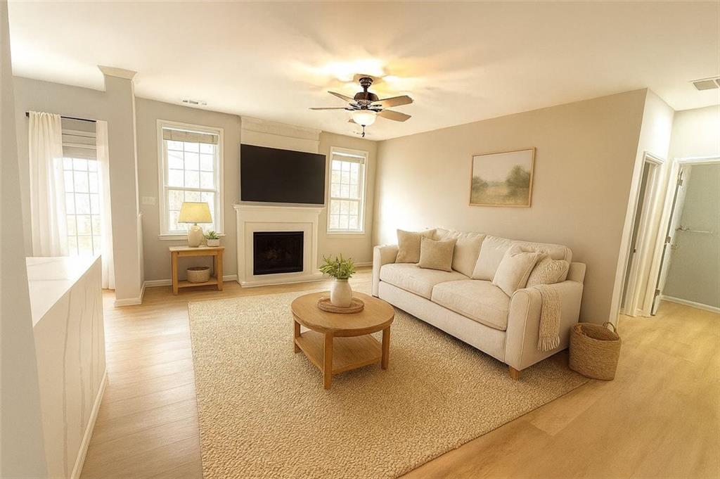 1505 Wedgefield Court Alpharetta, GA 30004 - Photo 3 of 61 a living room with furniture a fireplace and a flat screen tv