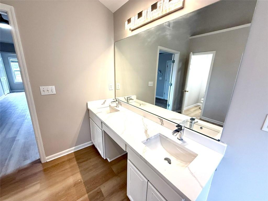 1505 Wedgefield Court Alpharetta, GA 30004 - Photo 39 of 61 a bathroom with a sink and a mirror