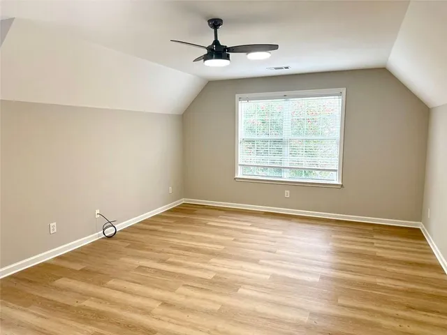 a view of empty room with ceiling fan