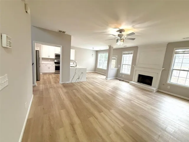 a view of a livingroom with a ceiling fan and window