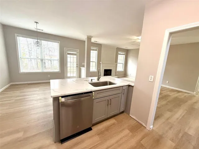 a view of kitchen with sink microwave and refrigerator