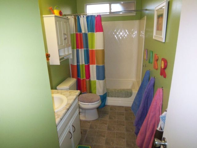 1140 Harpole Road Redding, CA 96002 - Photo 13 of 15 a bathroom with a toilet and shower curtain