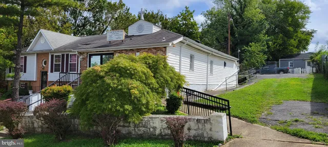 a house that has a tree in it with wooden fence