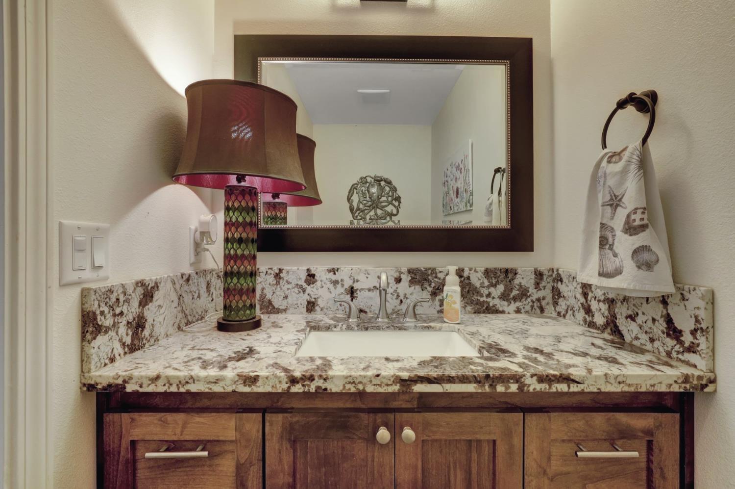 6718 Cross Star Trail Loma Rica, CA 95901 - Photo 12 of 54 a bathroom with a granite countertop sink and a mirror