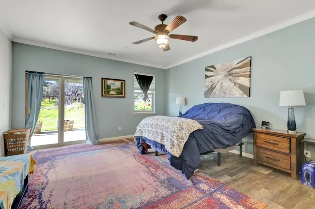 a bedroom with a bed and a flat tv screen on dresser