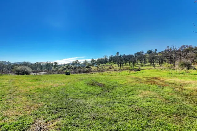 a view of a house with a yard and sitting area
