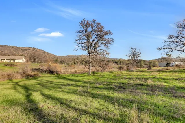 an aerial view of residential house with outdoor space and seating