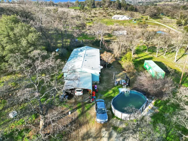 an aerial view of a house with a big yard