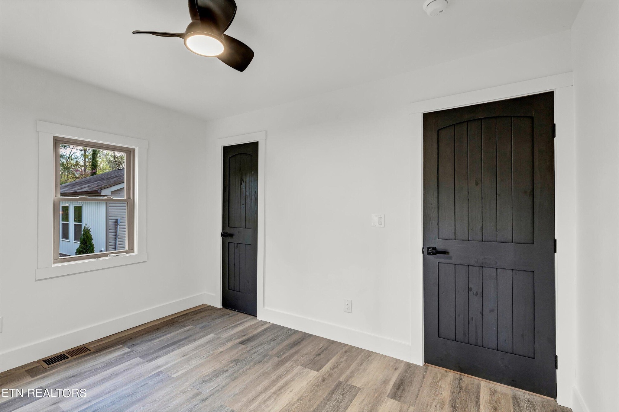 2209 Belt Road Knoxville, TN 37920 - Photo 27 of 36 a view of an empty room with wooden floor and a window