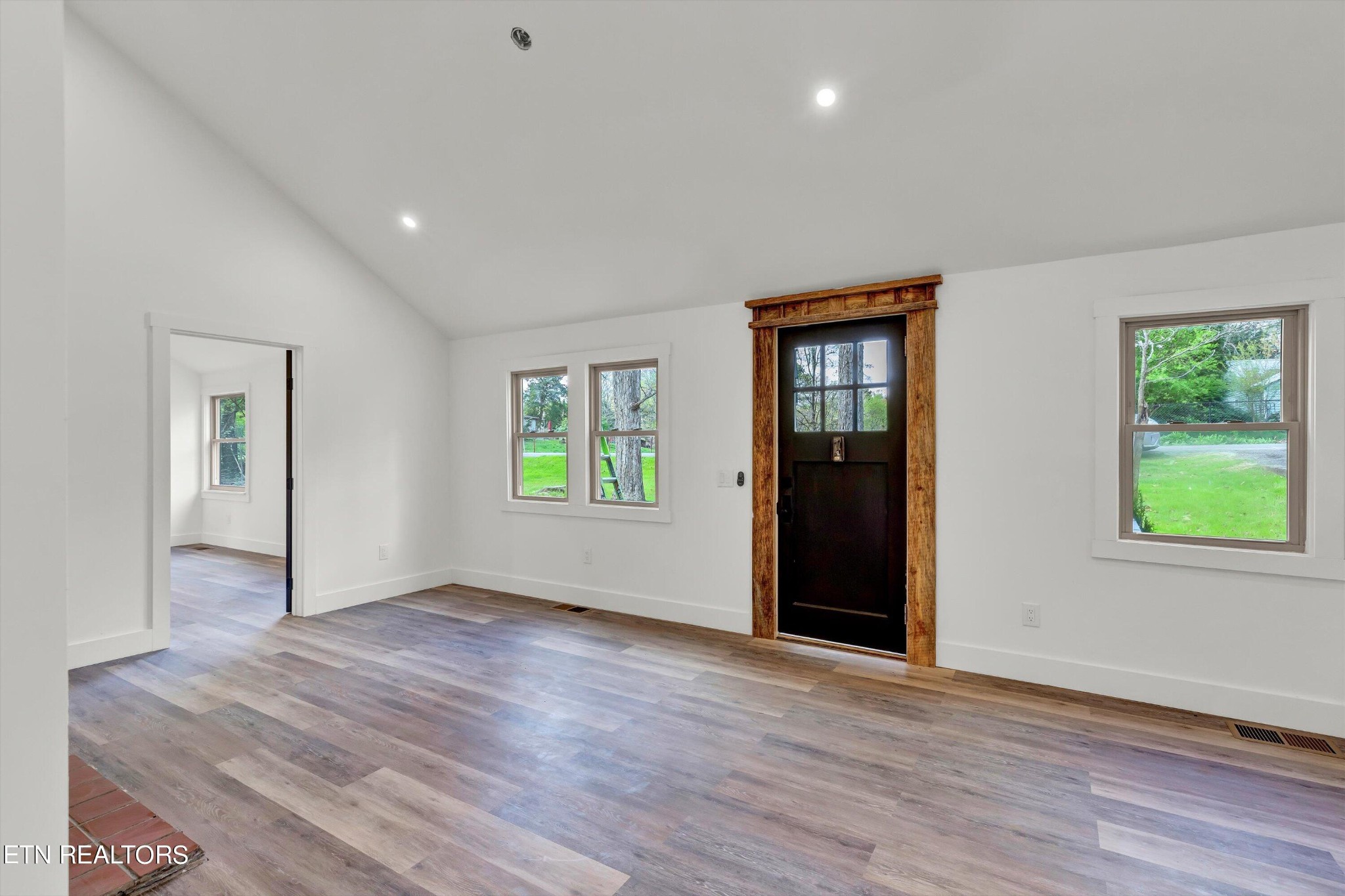 2209 Belt Road Knoxville, TN 37920 - Photo 9 of 36 a view of an empty room with wooden floor and a window