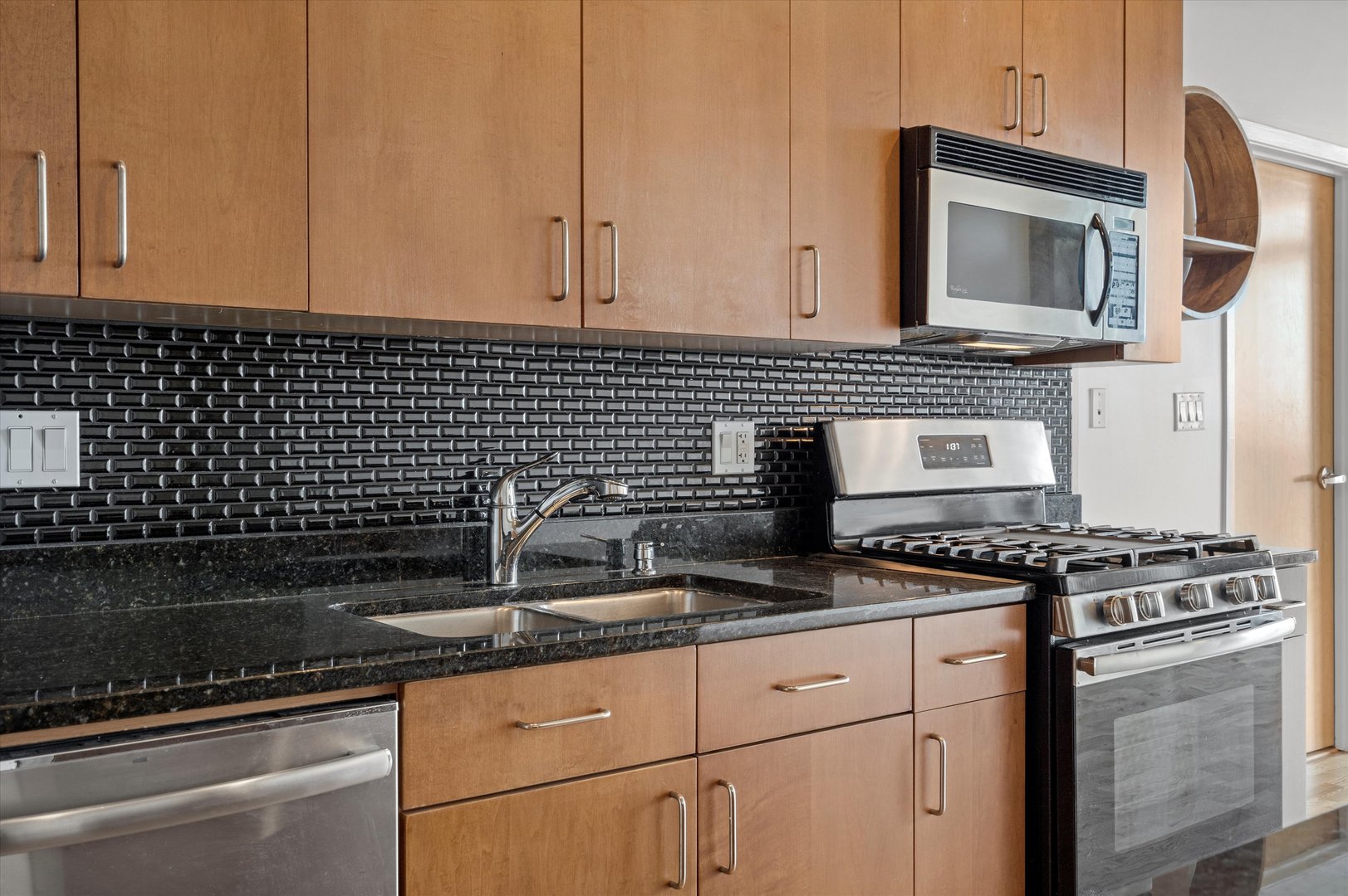 321 South Sangamon Street, Unit 804 Chicago, IL 60607 - Photo 3 of 14 a kitchen with granite countertop a sink stove and cabinets