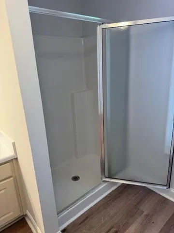 a bathroom with a glass shower door