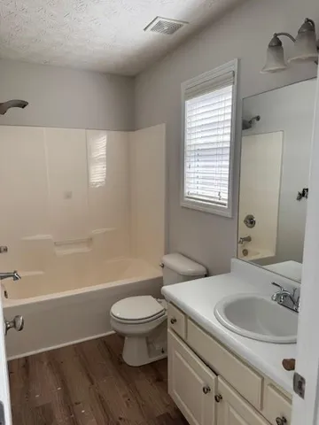 a bathroom with a sink a toilet and a bathtub